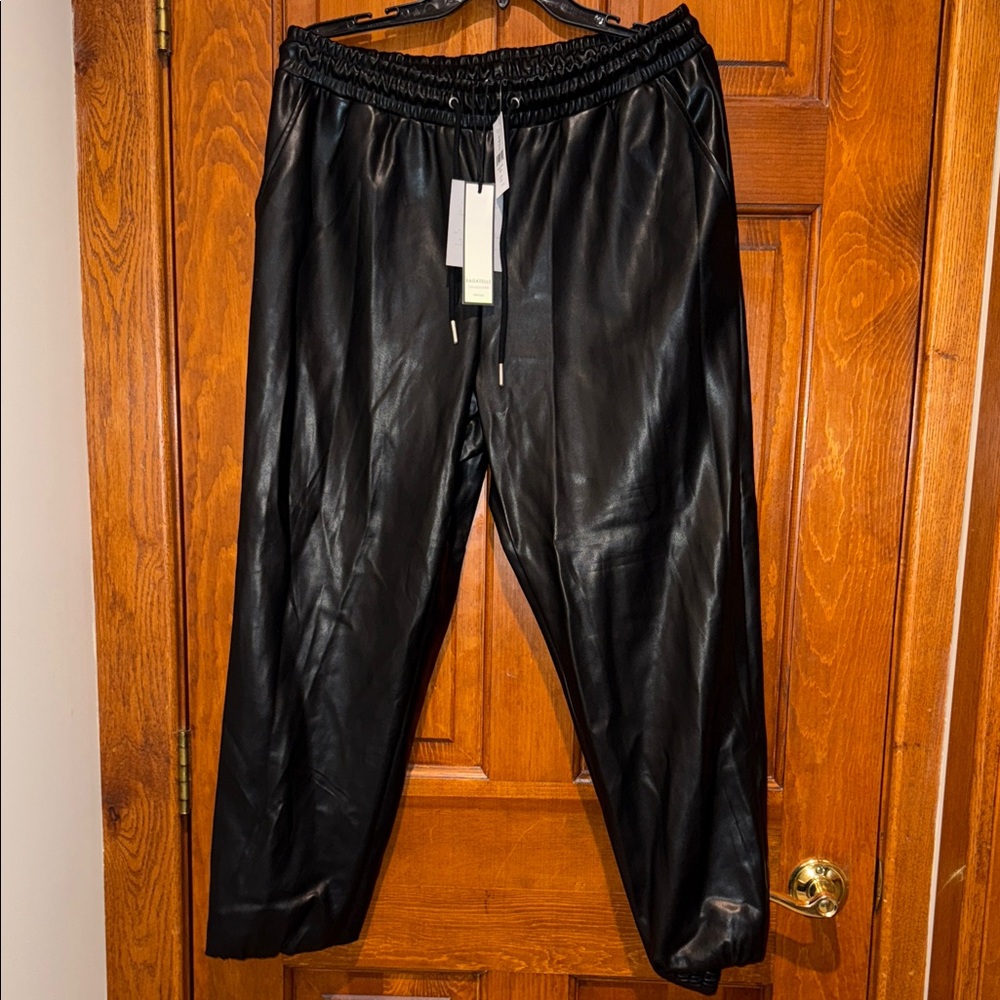 Women’s black leather pants cuffed ankles